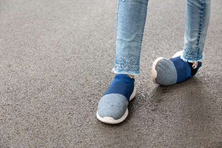 Crippled,woman disabled,people with disabilities or accident ankle sprain while jogging,run in outdoor park,feel pain,foot asian child girl injuries from exercise or walk,trip over,stumble sprained ankleの写真素材