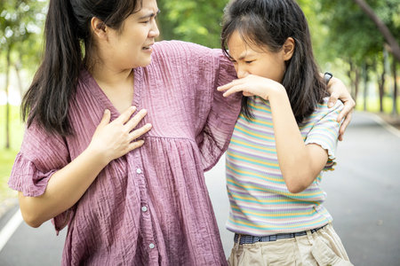 Foul-smelling woman was hug her daughter while her child girl closing nose and can smell the armpit...