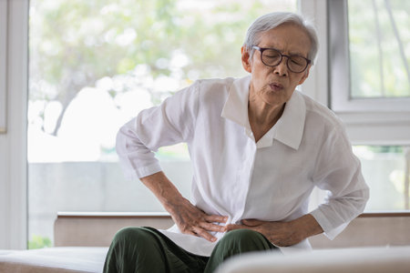 Sick senior patient with belly pain,severe stomach ache,symptoms gastrointestinal system...