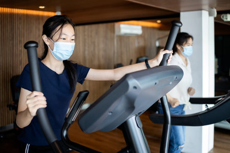 Two asian people wearing a protective masks,workout in new normal conditions under...