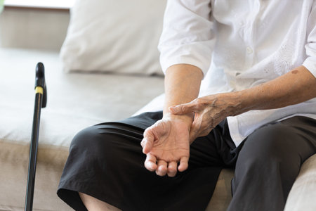 Old elderly people with wrist injury,bone pain in wrist,numbness or beriberi,asian senior woman suffering from De quervain's disease,weakness in hand,concept of arthritis,arthritic nerve,tendonitisの写真素材