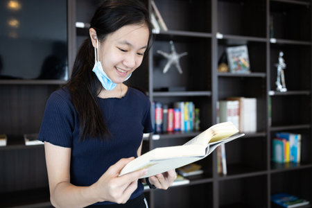 Asian student girl in a protective medical mask under her chin,wrong way to wear a face mask,child...