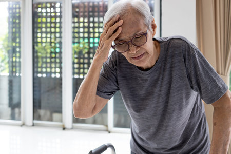 Tired asian senior woman touch her head with hand,symptoms of vertigo illness or meniereâ€™s...