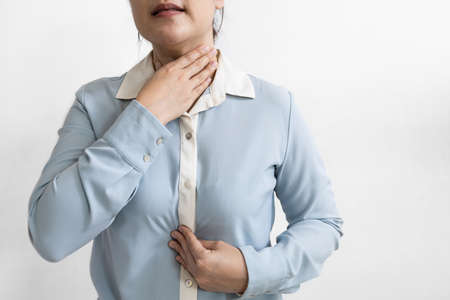 Asian female patient with gastroesophageal disorders,acid reflux disease,gastritis,indigestion,heartburn,burning sensation in the chest epigastric area,regurgitation of stomach acid,health problemsの写真素材