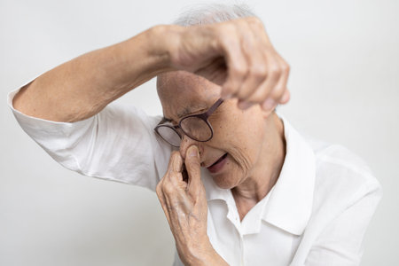 Armpit smelly or the body odor foul,annoyed asian senior woman sniffing her armpit,smelling...