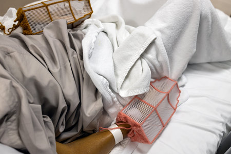 Hands of patient wearing protective equipment gloves to prevent pull the saline bottle,medical...