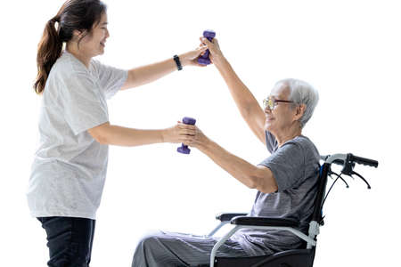 Happy senior woman enjoying exercise with dumbbells,smiling elderly doing physical therapy for health and strength during her recovery,isolated white background,healthy lifestyle,health care conceptの写真素材