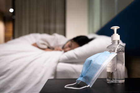 Hand sanitizer bottle and medical protective mask,alcohol antiseptic gel to clean the hands and kill infection,prevent disease,fight against of virus outbreak,health care and hygienicの写真素材