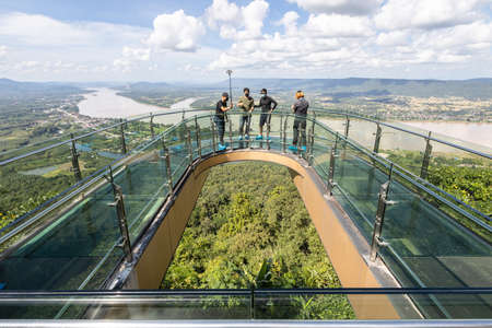 Nong Khai,Thailand-November 4,2021:tourists visit the glass bridge,standing to take selfies at the skywalk in Temple of Pha Tak Sue,Skywalk and new landmark at Wat Pha Tak Sue in Sangkhom districtのeditorial素材