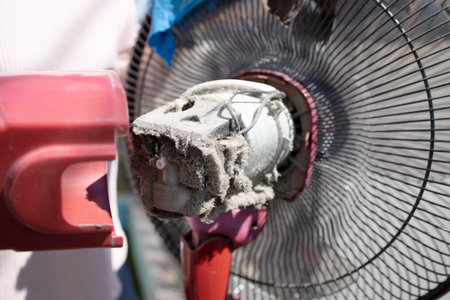 Close up,The electric fan motor was covered in dirt,full of dust inside the fan,dusty clogged motor...