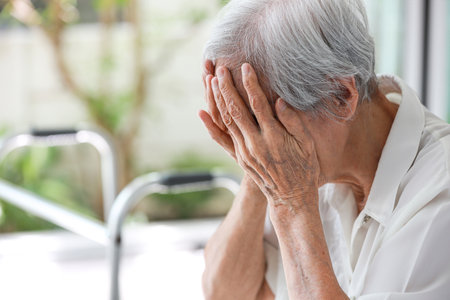 Depressed asian senior woman with depression,anxiety,depressive illness,tired old elderly patient crying alone at home,debilitating of disease,emotional problems,mood (affective)disorder,mental healthの写真素材