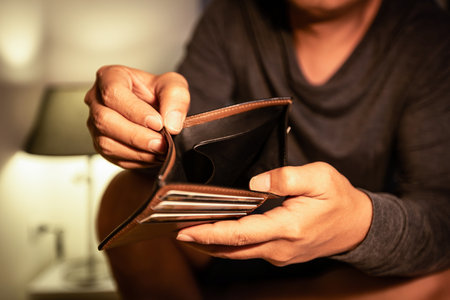 Concept of Bankruptcy,Unemployment,financial liquidity problems, finance trouble,Unemployed asian man opening empty wallet,no cash,money problem,deflation,inflation crisis,Global economic depressionの写真素材