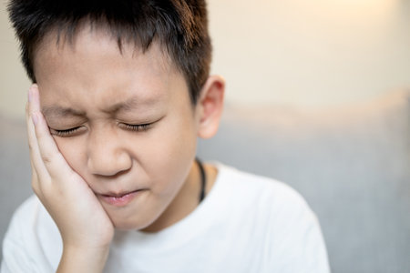 Child boy suffering from Gingivitis,Periodontitis,painful in jaw,inflammation of gums,ache in teeth,tooth decay in children,bad toothache,hyper-sensitive teeth,tooth root pain,dental caries problemsの写真素材
