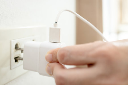 Close up,Defective charging cord,broken mobile charger cable,old electrical equipment deteriorates,dangerous risk of electrical leakage,accident damage from electric shock,care and maintenance conceptの写真素材