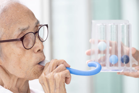 Asian senior woman using incentive spirometer,check her lung,pulmonary function test,measuring the...