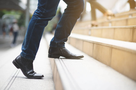 A man walking up the stairs to achieve the goal