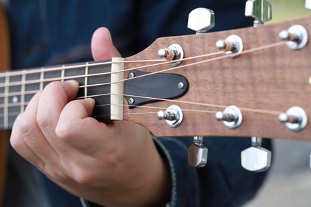 Men playing acoustic guitar close up