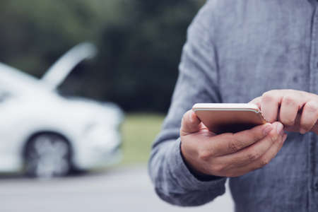 man using smart phone for help.concept car service.の写真素材