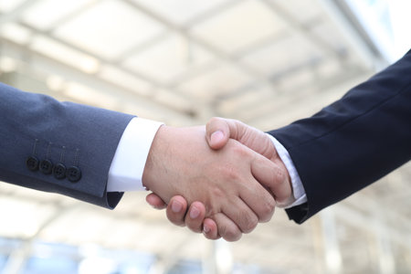 A close-up of a business handshake between two co-workers, office workers.の写真素材