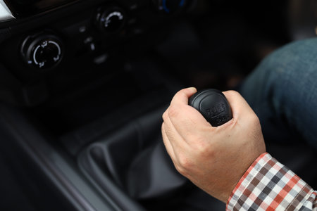 Car driving concept The driver changes gear.