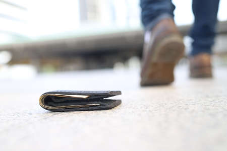 The purse fell on the sidewalk. Before someone will keep goingの写真素材