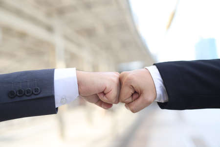 Fighting, disruption and dealing with economic conflicts, competing with business rivals during , two punches hit a building background effect. Battle conceptの写真素材