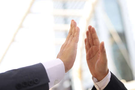 Businessmen keep their hands spaced to prevent Cowit 19.の写真素材