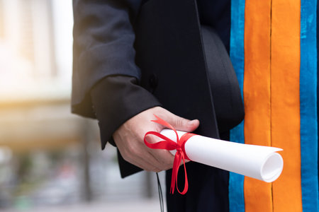 Happy graduate holding diploma education concept.