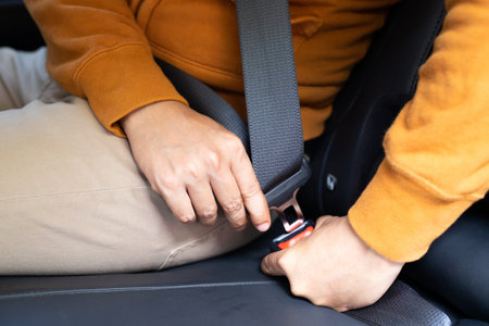 Man fastening seat belt in car. Safety and protection concept.の写真素材