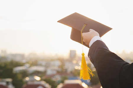 Graduation hat with diploma on the background of the city. Education concept.の写真素材