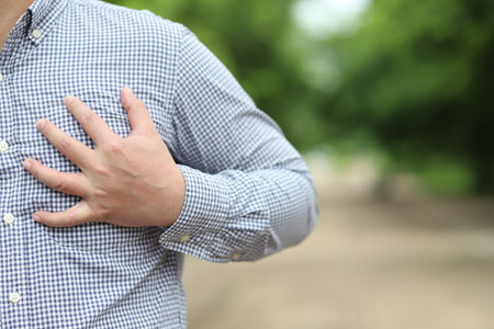 Man suffering from chest pain outdoors, closeup. Health care conceptの写真素材