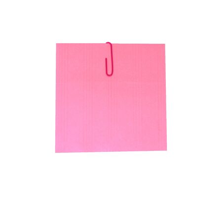 A red paperclip with blank pink notepaper. Pink sheet for your message or adding more text. Memo note with paper clipの写真素材