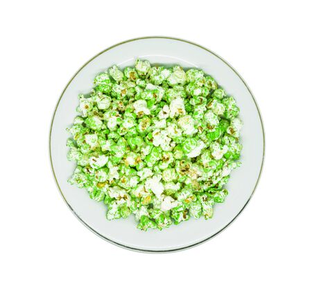 A plate of popcorn isolated on white background. Tasty popcorn on white plateの写真素材