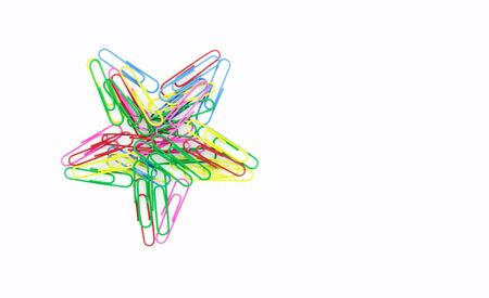 Series of colorful paper clips with star shape on white background. Decorative paper clips in pink, yellow, green, red and blue colorsの写真素材