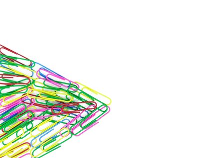 Pile paper clips in the form of a triangle on white background. Decorative paper clips in pink, yellow, green, red and blue colorsの写真素材