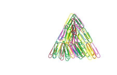 Multicolored paper clips in the form of a triangle on white background. Decorative paper clips in pink, yellow, green, red and blue colorsの写真素材