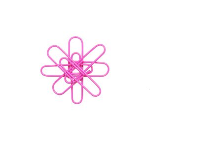 Purple paper clips in the form of a flower on white backgroundの写真素材