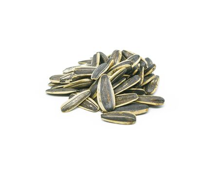 a pile of sunflower seeds isolated on white backgroundの写真素材