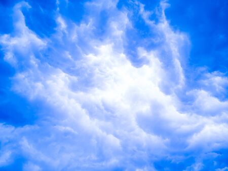 Beautiful blue sky and bright white clouds for background and wallpaperの写真素材