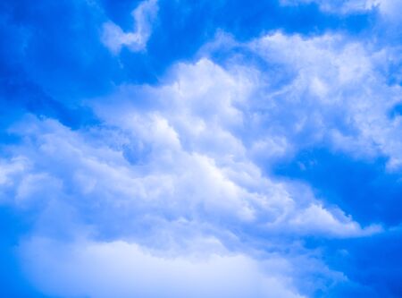 Beautiful blue sky and bright white clouds for background and wallpaperの写真素材