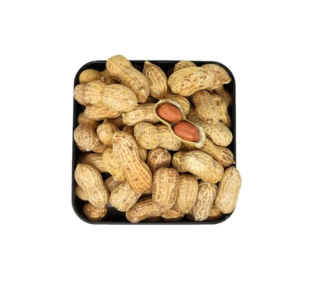 Pile peanuts in a black box isolated on white background. Top viewの写真素材
