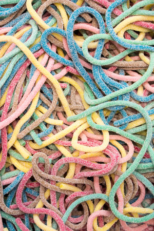 Fruit jelly, sprinkled with sugar. Sweets, dessert, sweets in the form of worms or snakes. Baby...
