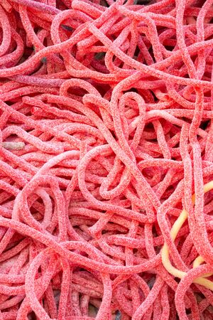 Fruit jelly, sprinkled with sugar. Sweets, dessert, sweets in the form of worms or snakes. Baby delicacy.の写真素材