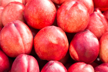 Ripe Nectarines on the market. Background of Nectarines close-up.