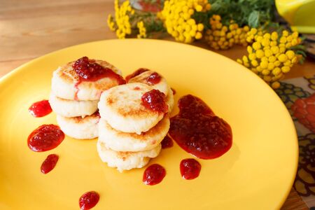 Cheese Pancake with raspberry sauce. Home cooking. Cheesecakes for Breakfast. Healthy diet. Dairy products are rich in protein and calcium.の写真素材