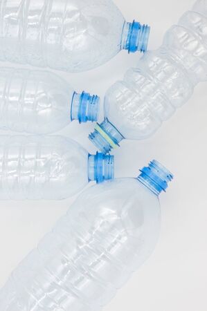 Empty used plastic bottles on a white background. The concept of the problem of environmental pollution by plastic and other nondegradable waste in nature.の写真素材