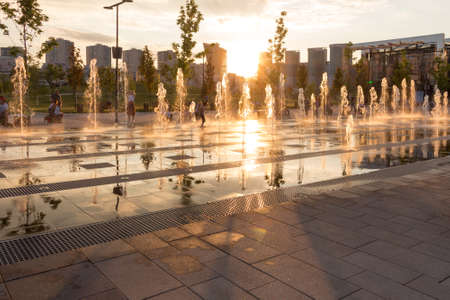Russia, Moscow - 06 July 2020: Khodynka field, Park and residential area. Fountain at sunset of a summer dayのeditorial素材