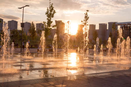 Russia, Moscow - 06 July 2020: Khodynka field, Park and residential area. Fountain at sunset of a summer dayのeditorial素材