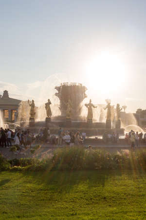 Moscow, Russia - July 26, 2020: Central Pavilion and Central Avenue at VDNKh. Summer day. Flowerbeds are decorated with red roses.のeditorial素材
