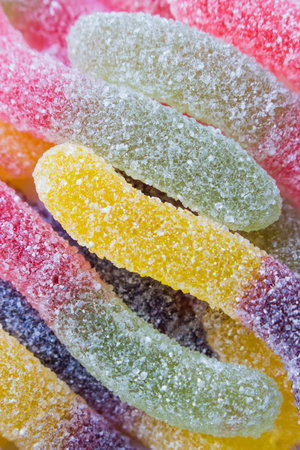 Fruit jelly, sprinkled with sugar. Sweets, dessert, sweets in the form of worms or snakes. Baby...